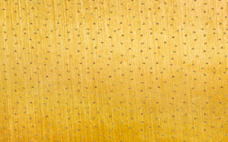 Gold wood with patterns over it