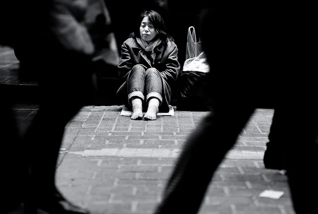a photo of a woman sitting on the road